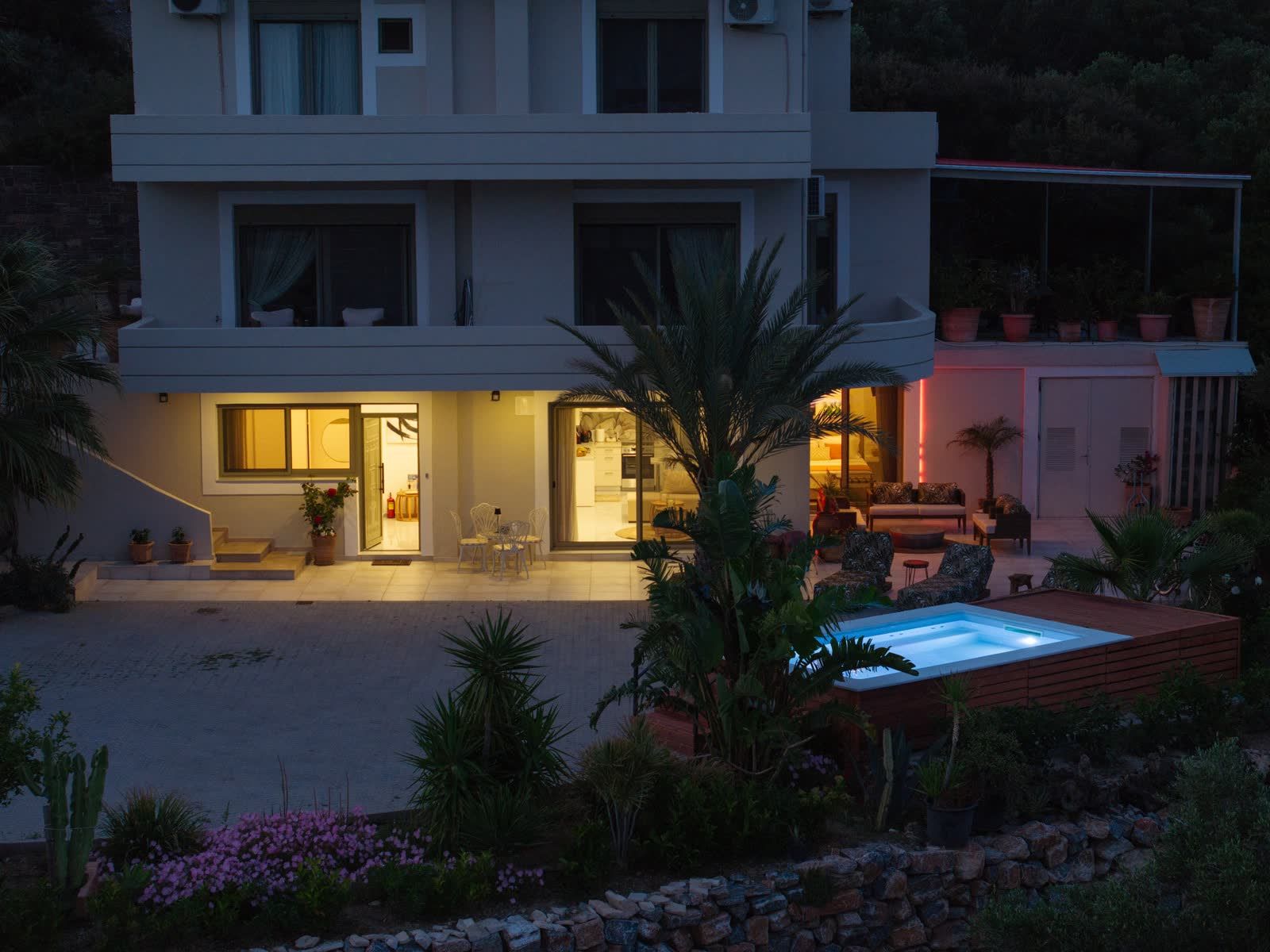 The house and pool at nightfall, seen from above