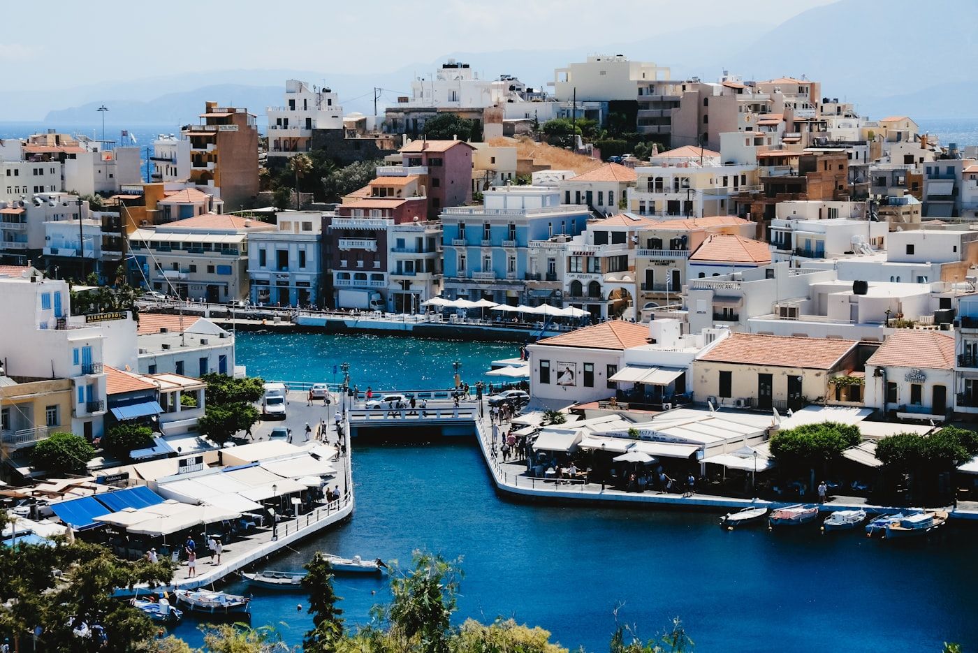 The harbour of Agios Nikolaos, fishing boats below whitewashed houses