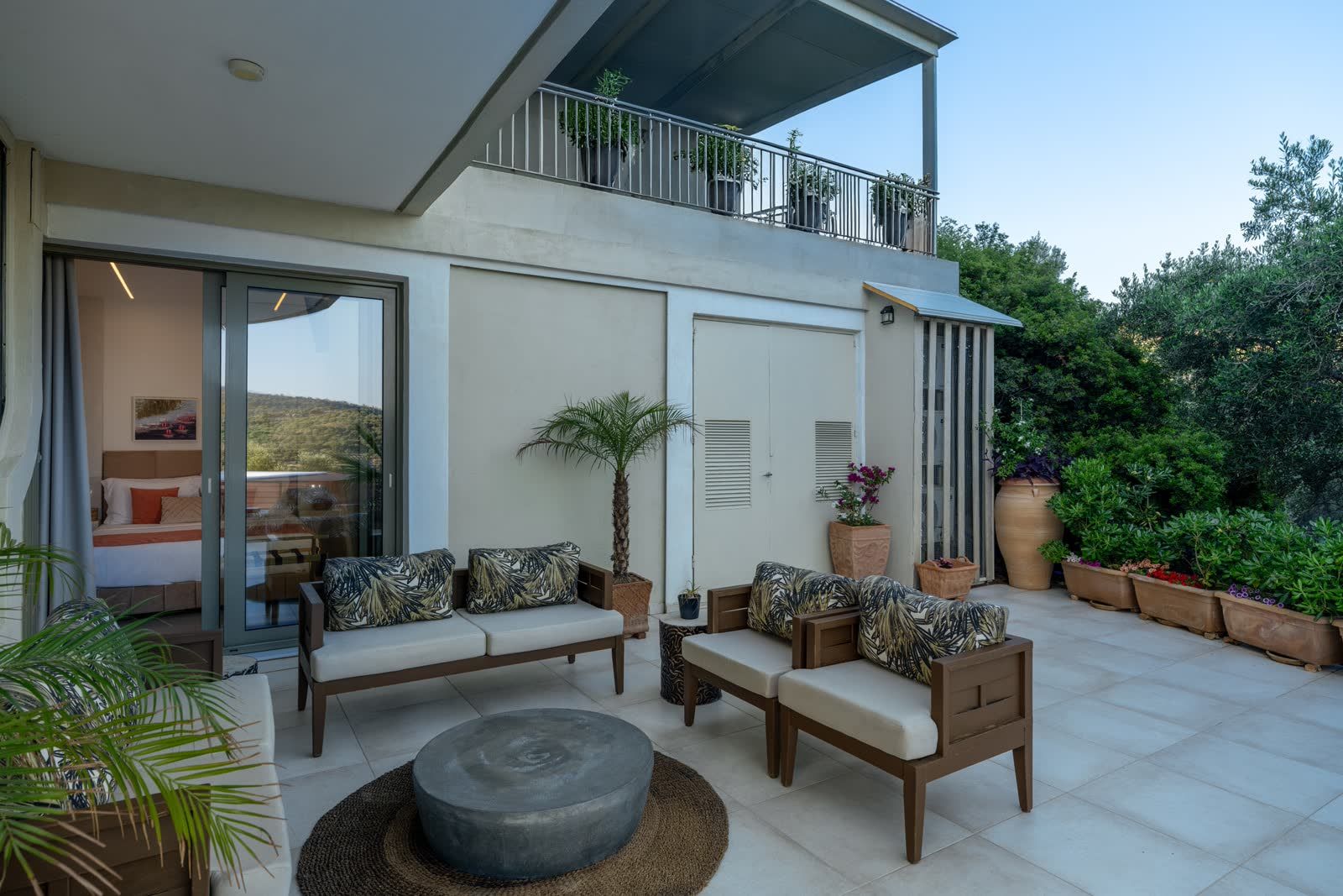 The lower terrace sofa, the balcony above and the grove all around