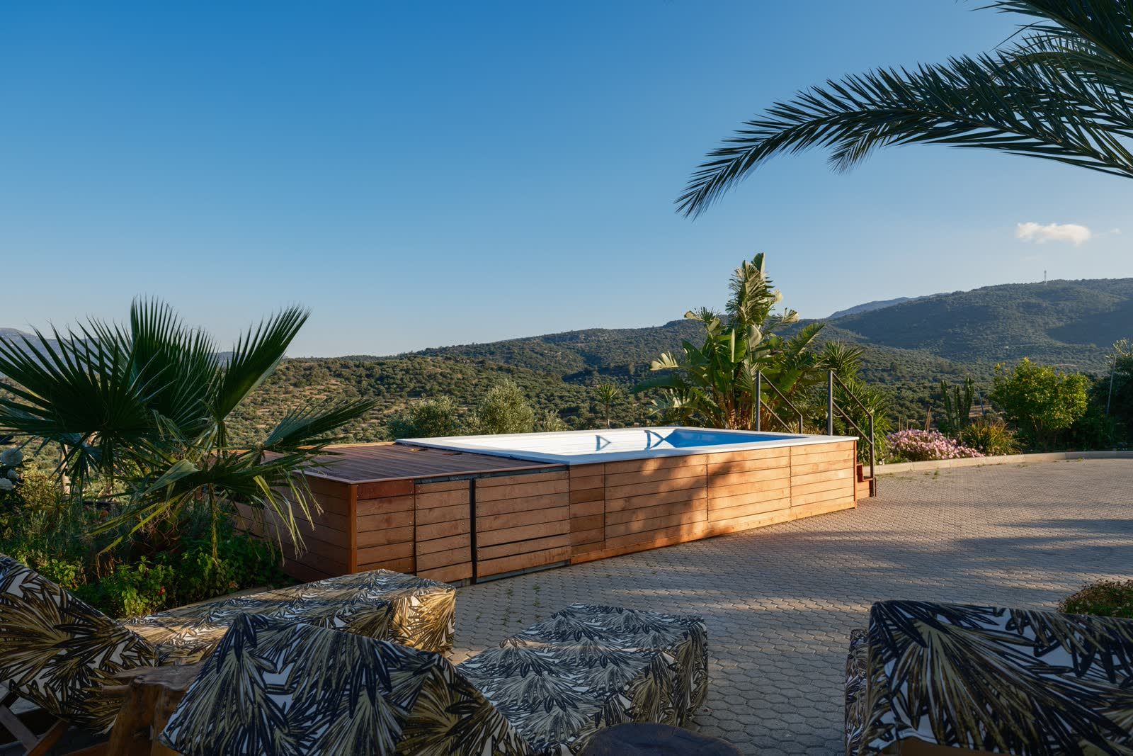The pool at golden hour, the mountains softening in the haze