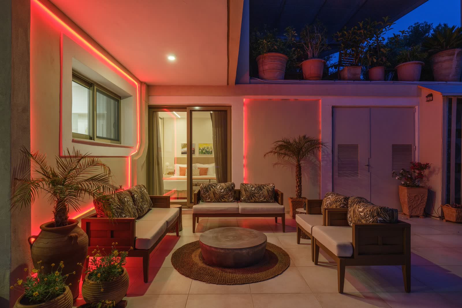 The terrace lounge after dark, lit softly along the walls