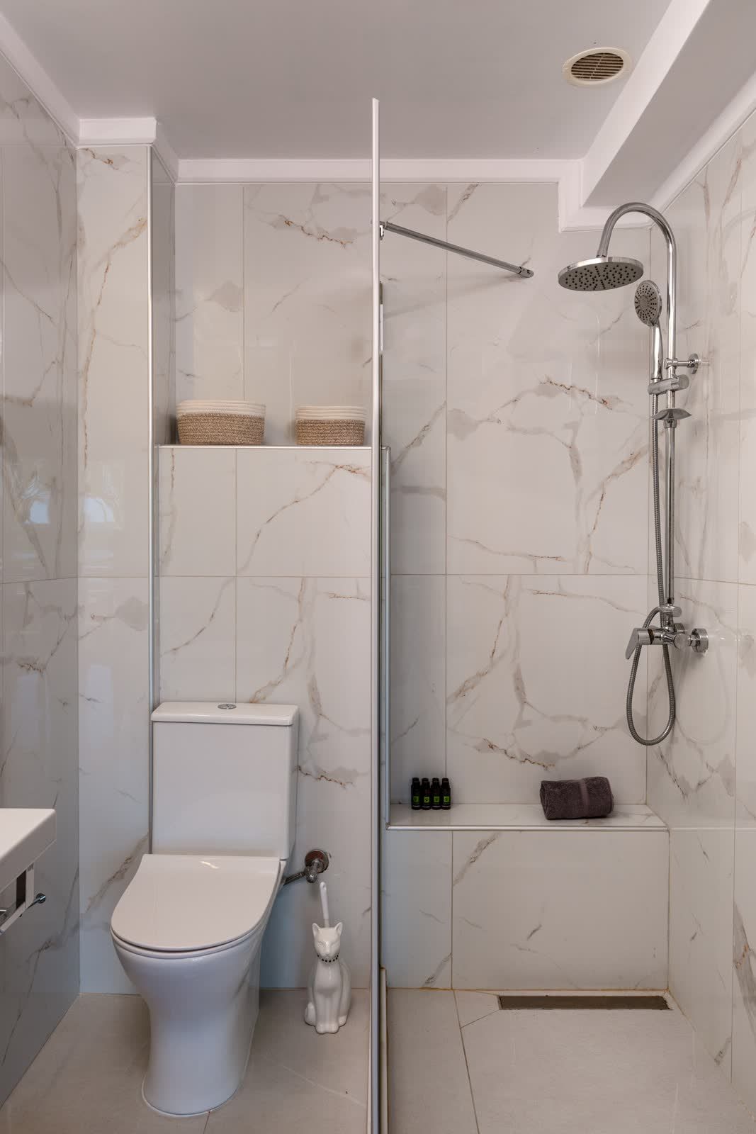 Rain shower in the marble bathroom