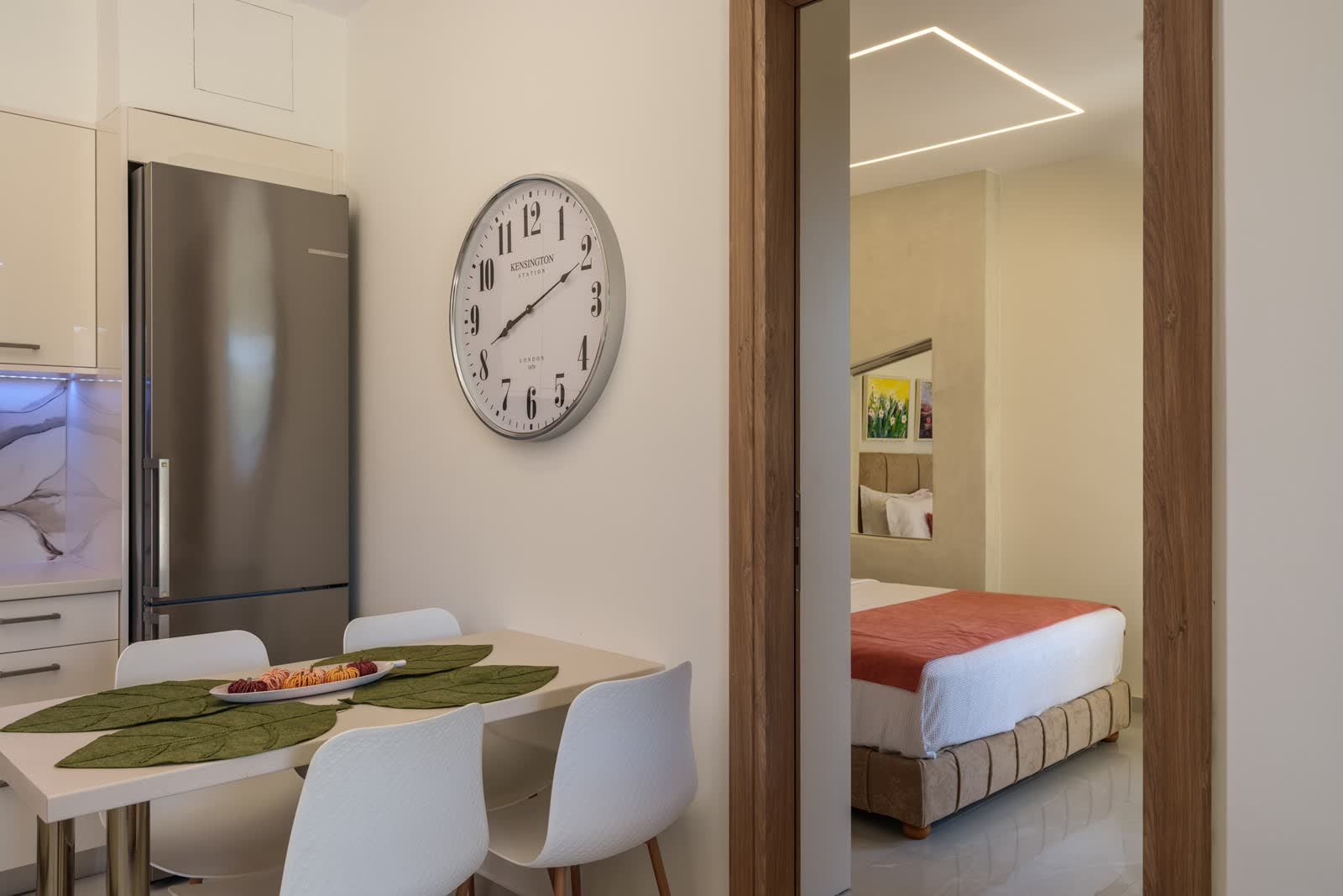 The kitchen and dining corner, the garden bedroom visible through its doorway