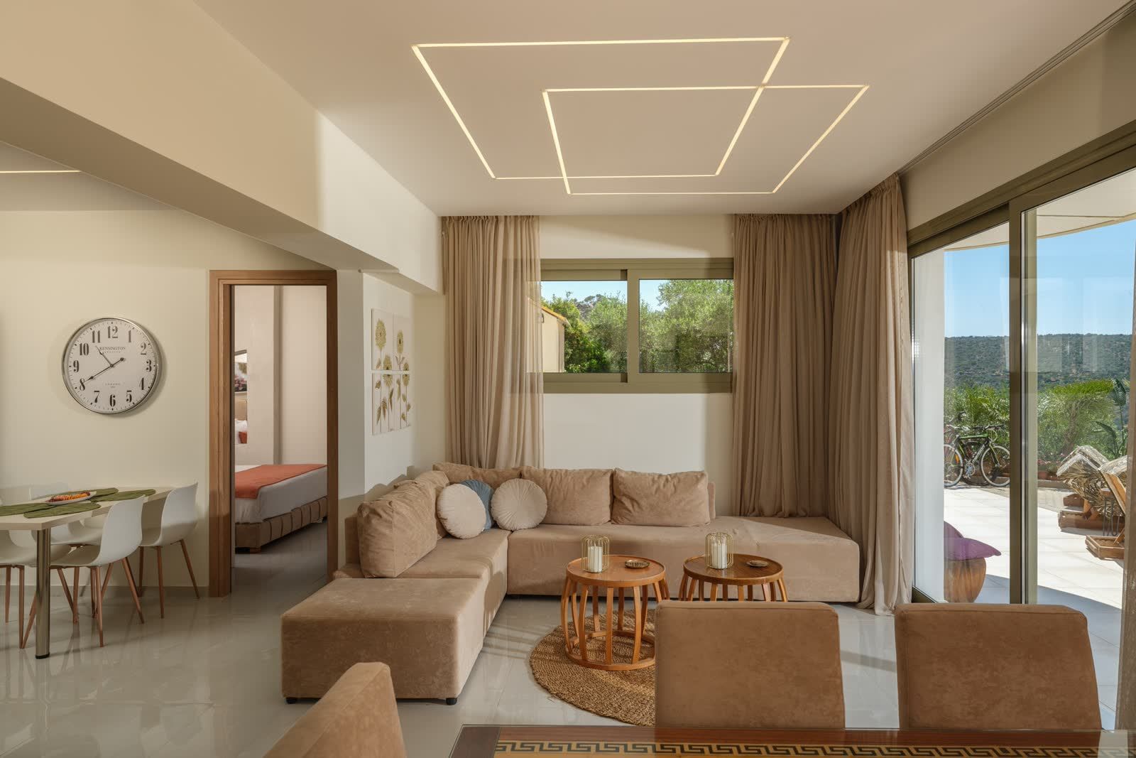 The open-plan living room, with the kitchen and both bedroom doors in view