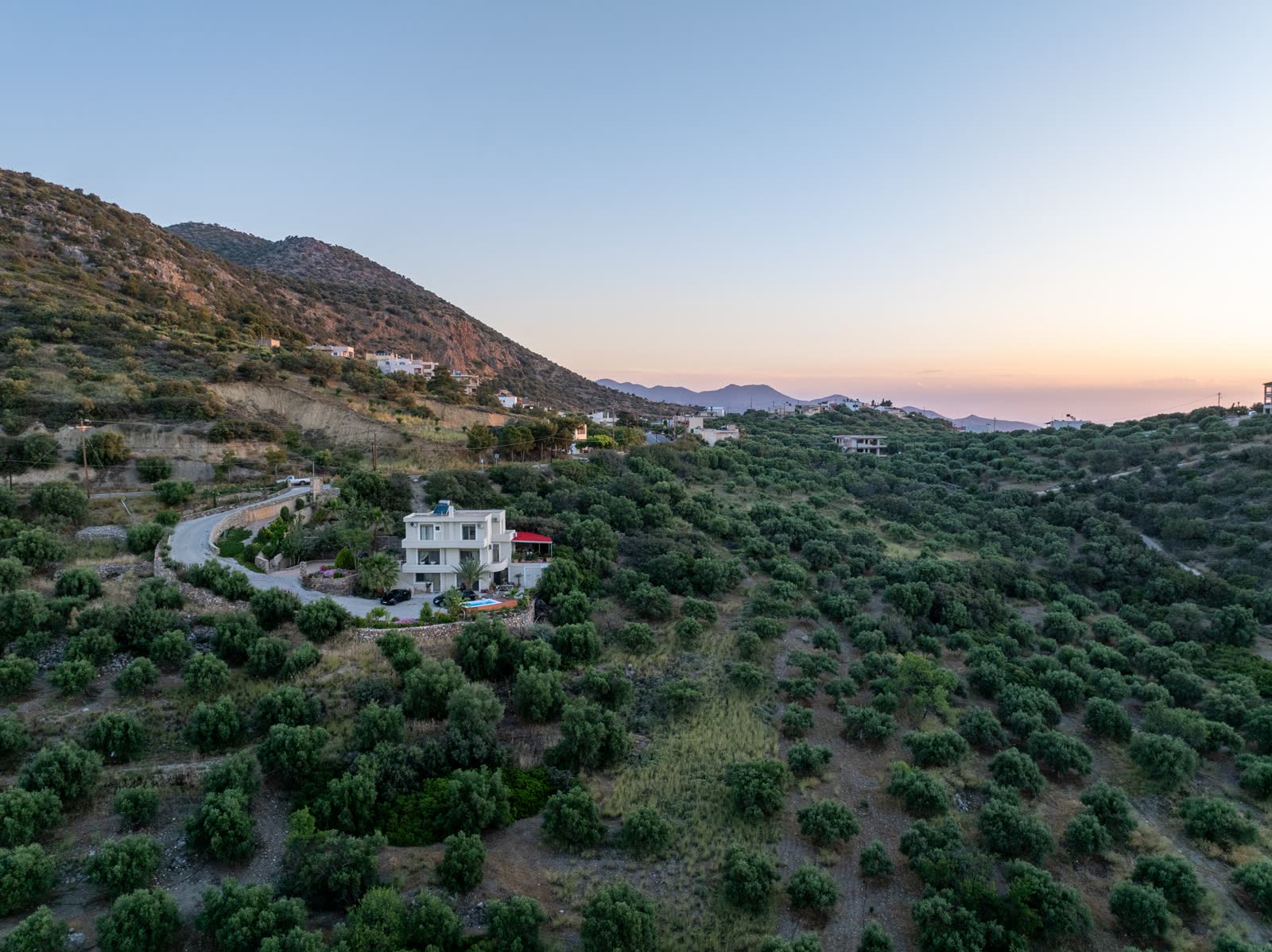 Sunrise over the house, the olive grove and the sea beyond