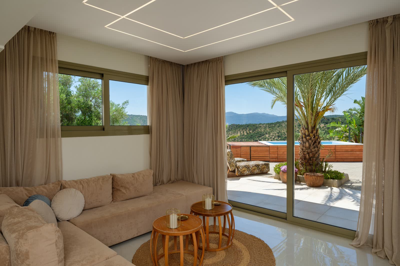 The living room sofa facing the terrace and pool